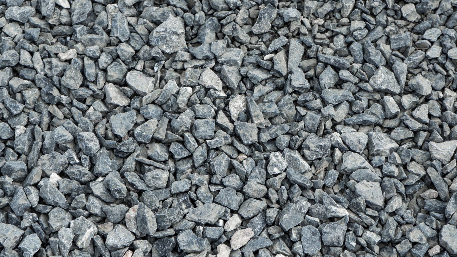 Gray crushed stone gravel texture with varied rock sizes